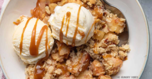 Scoop of vanilla ice cream on apple crisp